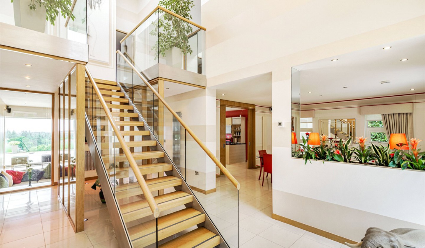 open staircase with glass panelling